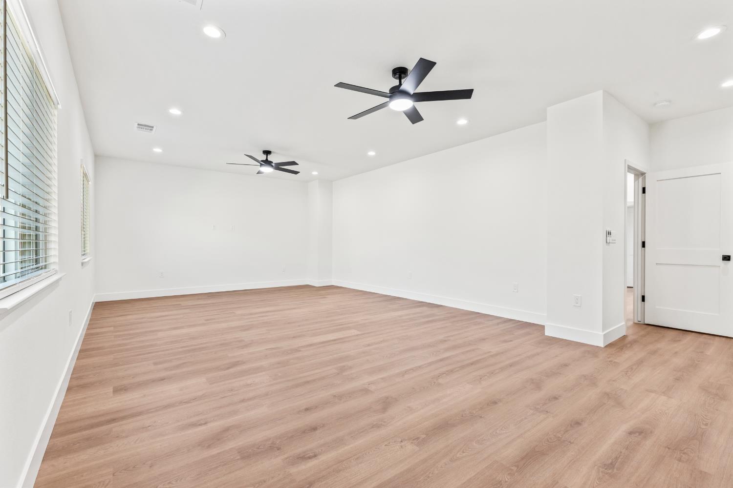 688 Cindy Drive Ripon, CA 95366 - Photo 39 of 57 wooden floor in an empty room with a window