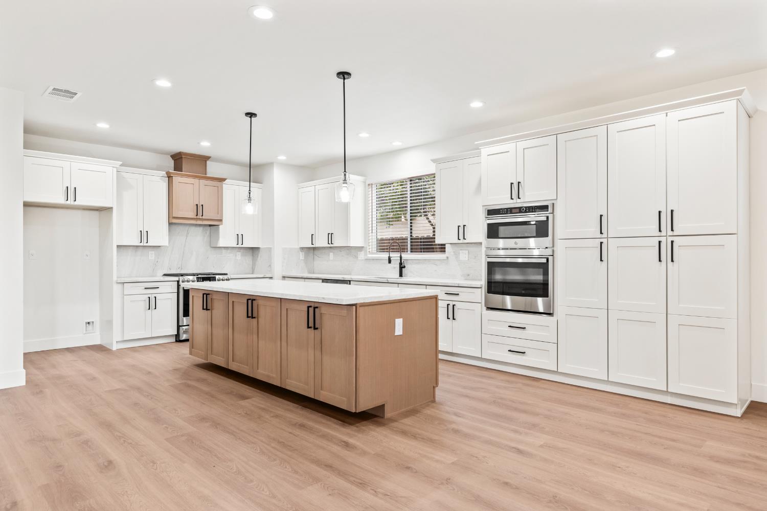 688 Cindy Drive Ripon, CA 95366 - Photo 10 of 57 a large kitchen with stainless steel appliances and white cabinets