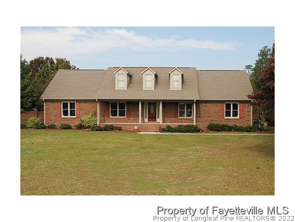 2651 Blossom Road Hope Mills, NC 28348 - Photo 1 of 25 a front view of a house with a yard