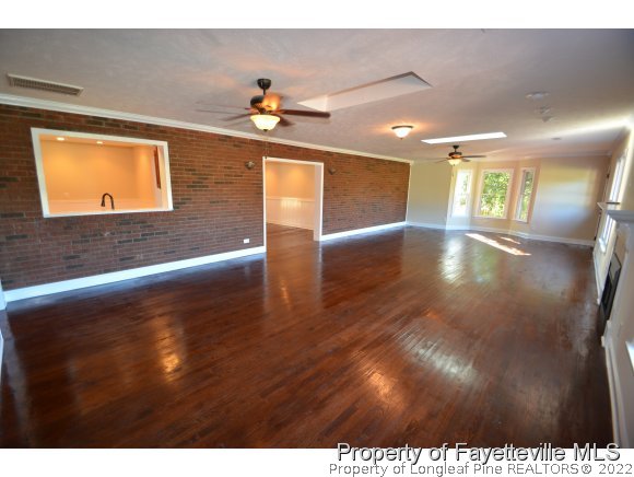 2651 Blossom Road Hope Mills, NC 28348 - Photo 5 of 25 a view of a hallway with wooden floor