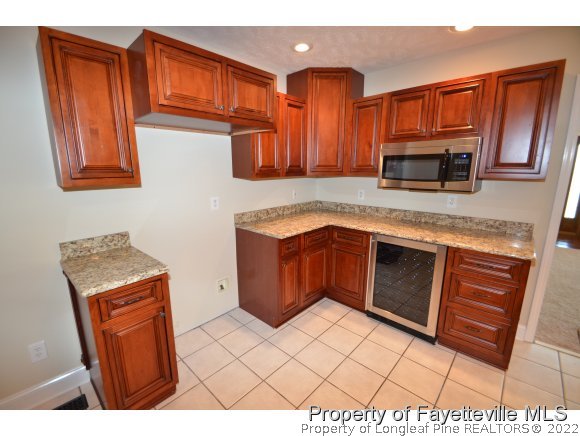 2651 Blossom Road Hope Mills, NC 28348 - Photo 8 of 25 a kitchen with stainless steel appliances granite countertop a stove a sink and a microwave