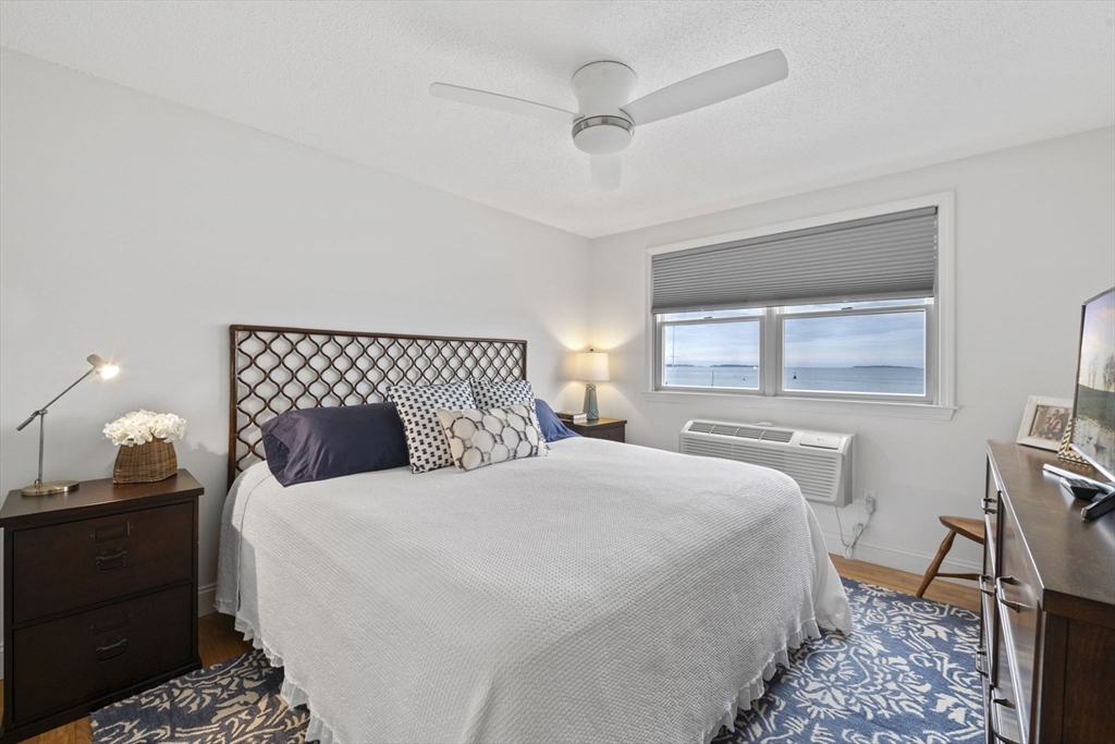 121 Water Street, Unit 44 Beverly, MA 01915 - Photo 13 of 24 a bedroom with a bed and a lamp on dresser
