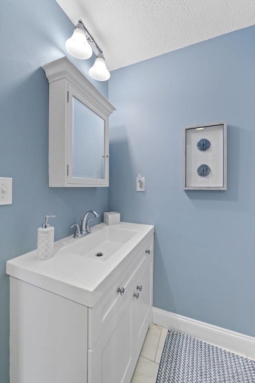 121 Water Street, Unit 44 Beverly, MA 01915 - Photo 16 of 24 a bathroom with a sink and a mirror