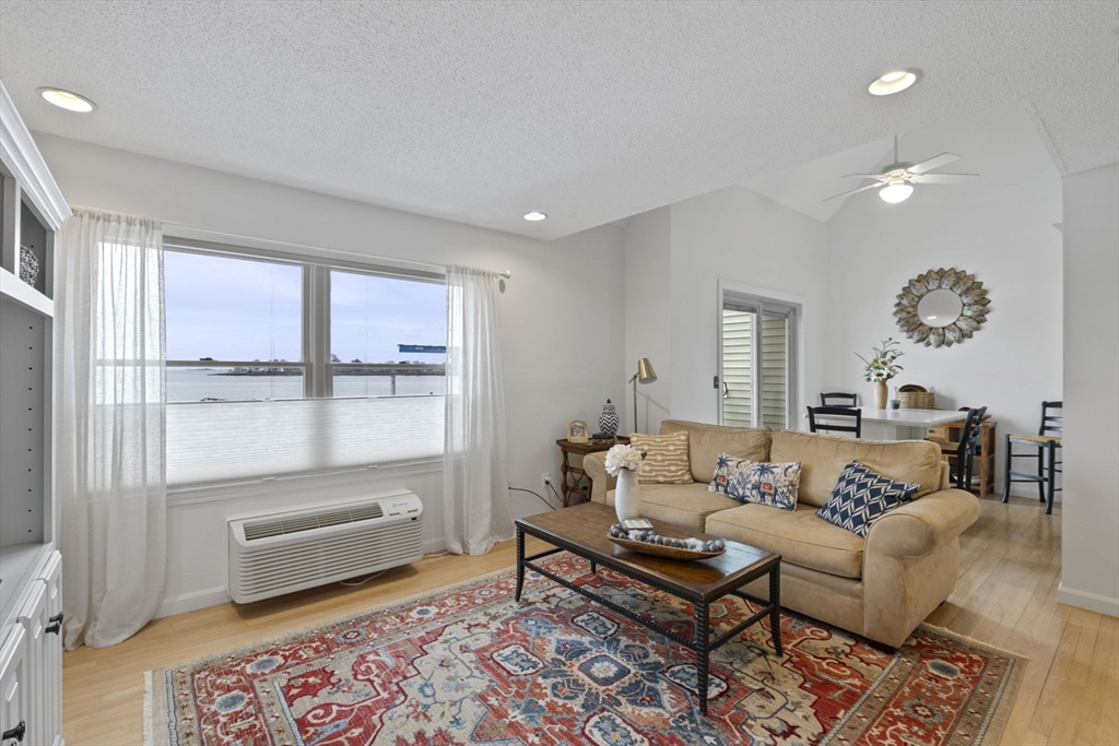 121 Water Street, Unit 44 Beverly, MA 01915 - Photo 2 of 24 a living room with furniture and a window