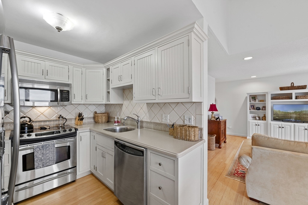 121 Water Street, Unit 44 Beverly, MA 01915 - Photo 9 of 24 a kitchen with stainless steel appliances granite countertop a stove a sink dishwasher and a refrigerator