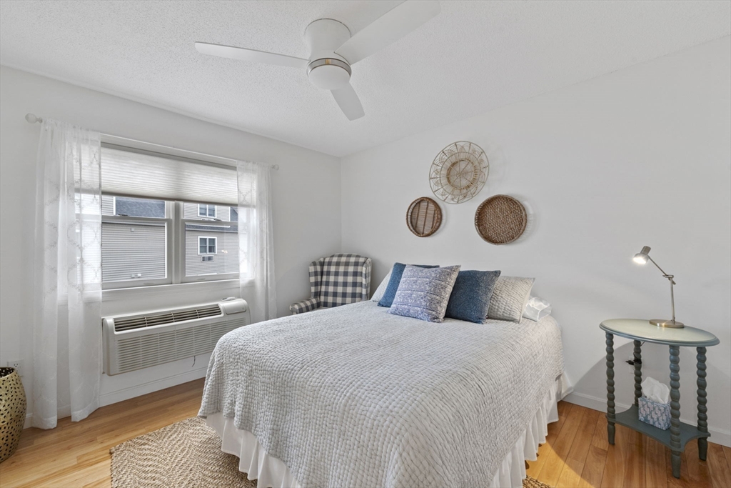 121 Water Street, Unit 44 Beverly, MA 01915 - Photo 10 of 24 a bedroom with a bed and chandelier