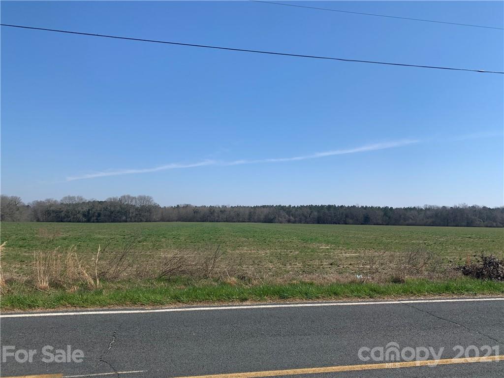 688 McLendon Road Morven, NC 28119 - Photo 1 of 9 a view of a green field with an ocean view