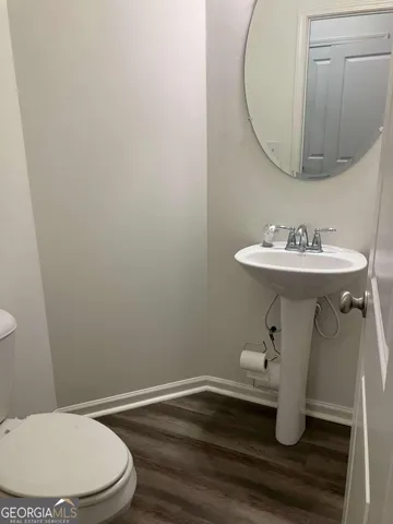 a bathroom with a sink mirror and toilet