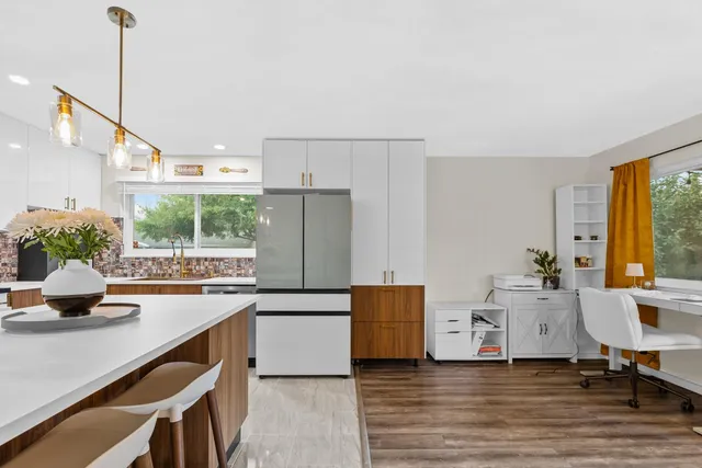 a kitchen with a sink a window and cabinets