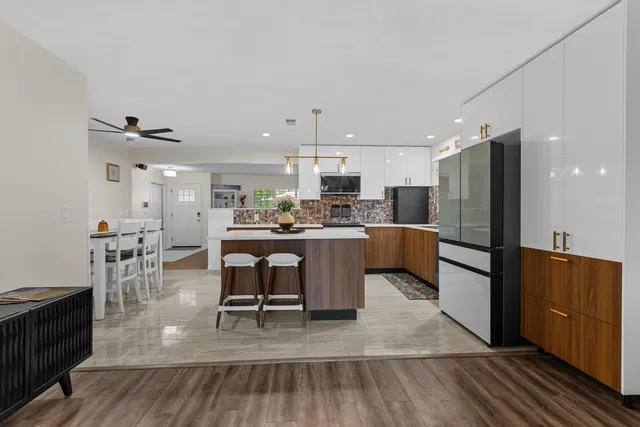 a kitchen with stainless steel appliances a refrigerator and wooden cabinets