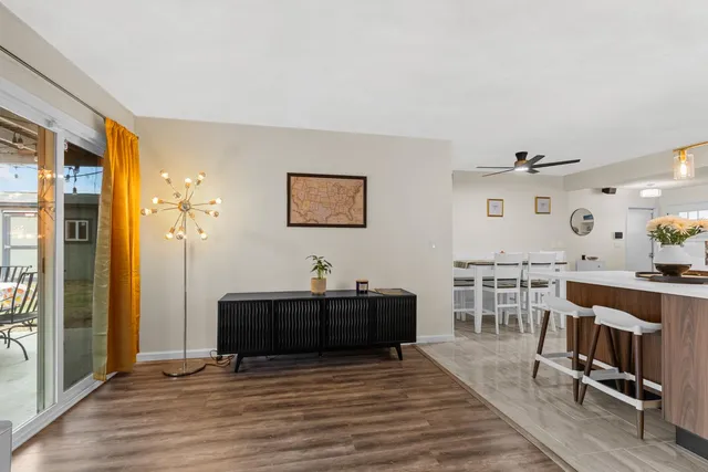 a living room with furniture a flat screen tv and a table