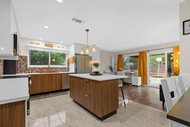 a kitchen with stainless steel appliances granite countertop a sink and a counter
