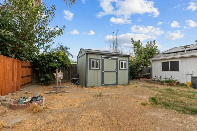 a view of a house with a tree in front of it