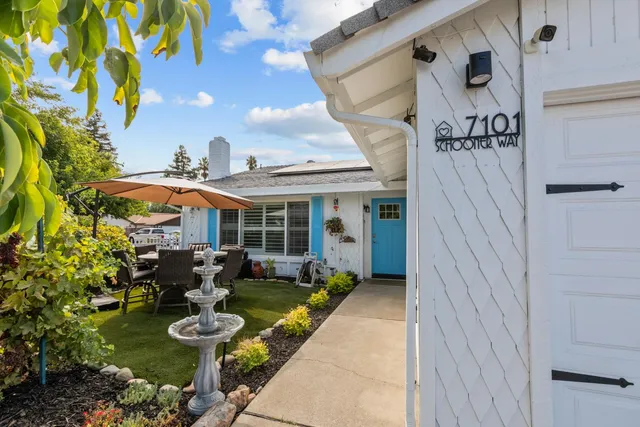 a view of a patio with table and chairs and potted plants