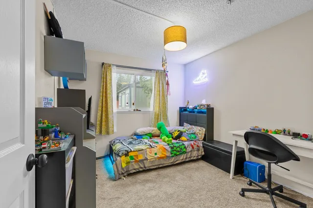 a bedroom with a bed and a chandelier