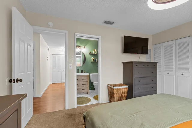 a bedroom with a bed and a television