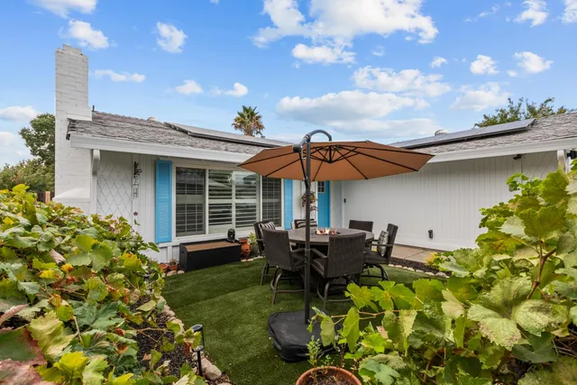 a view of a chair and table in the patio with a fire pit