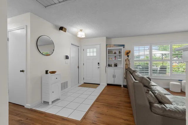 a spacious bedroom with a large bed and a large window