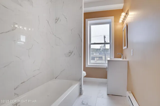 a bathroom with a bathtub and a shower