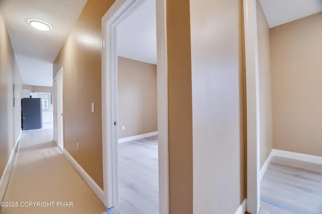 a view of hallway with wooden floor