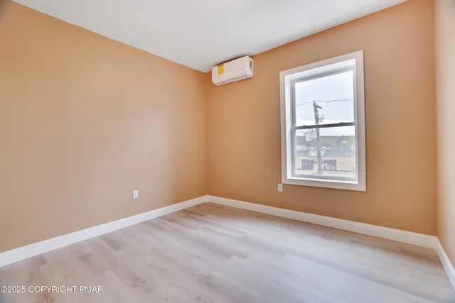 an empty room with windows and closet