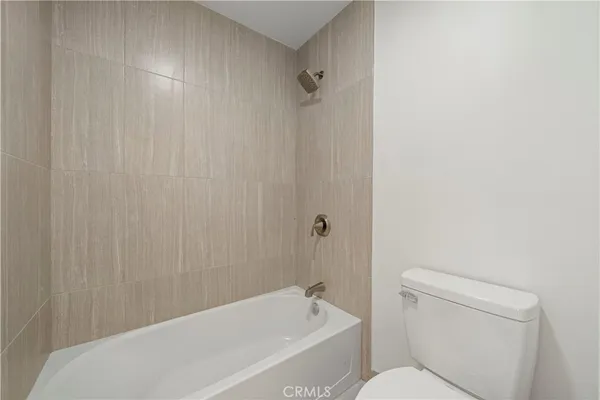 a bathroom with a toilet and a bathtub