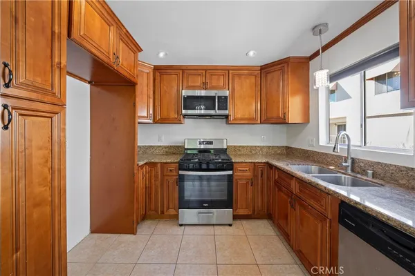 a kitchen with stainless steel appliances granite countertop a stove and a sink