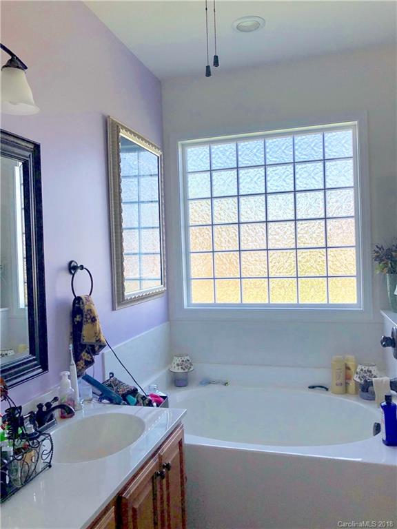 277 Yadkin Road Fletcher, NC 28732 - Photo 13 of 15 a bathroom with a tub sink and mirror