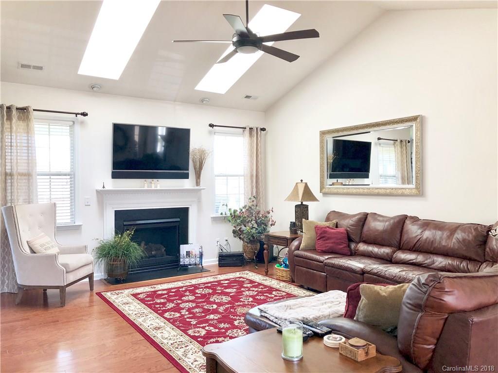 277 Yadkin Road Fletcher, NC 28732 - Photo 3 of 15 a living room with furniture a flat screen tv and a fireplace