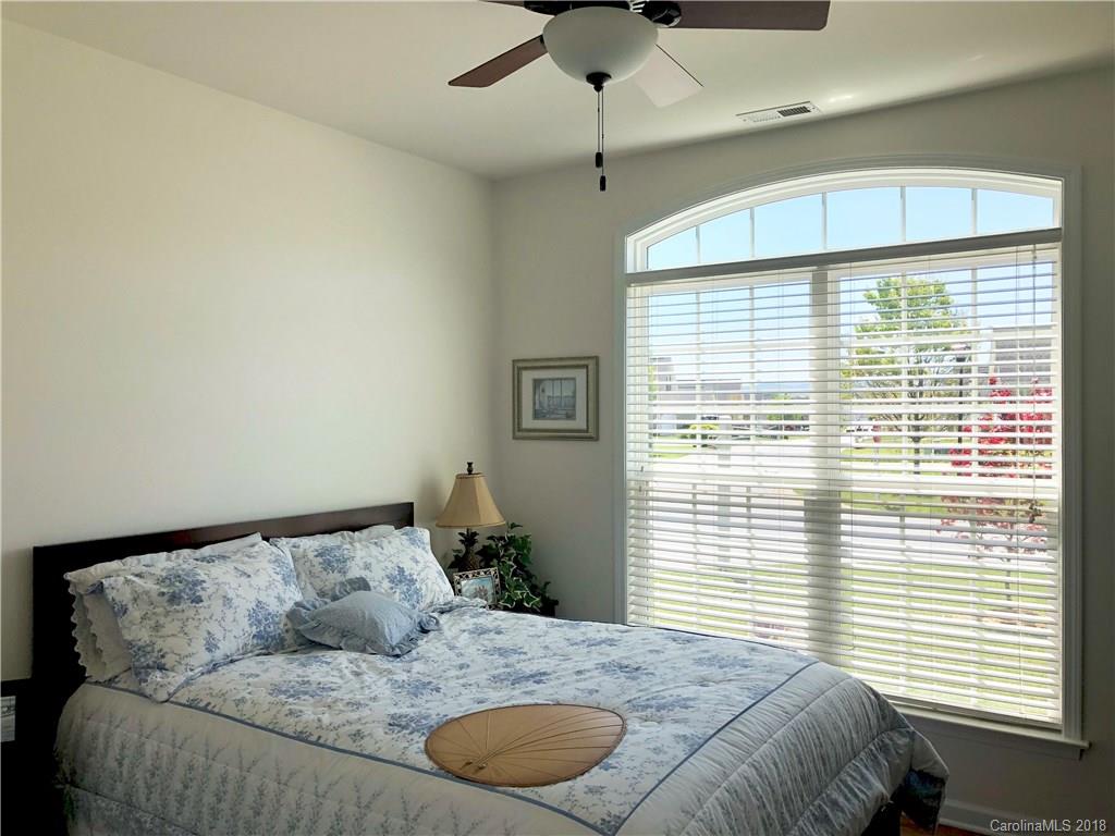 277 Yadkin Road Fletcher, NC 28732 - Photo 7 of 15 a bedroom with a large bed and a window