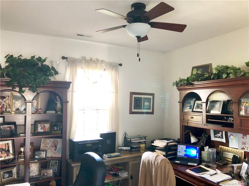 277 Yadkin Road Fletcher, NC 28732 - Photo 8 of 15 a living room with furniture a rug and a chandelier