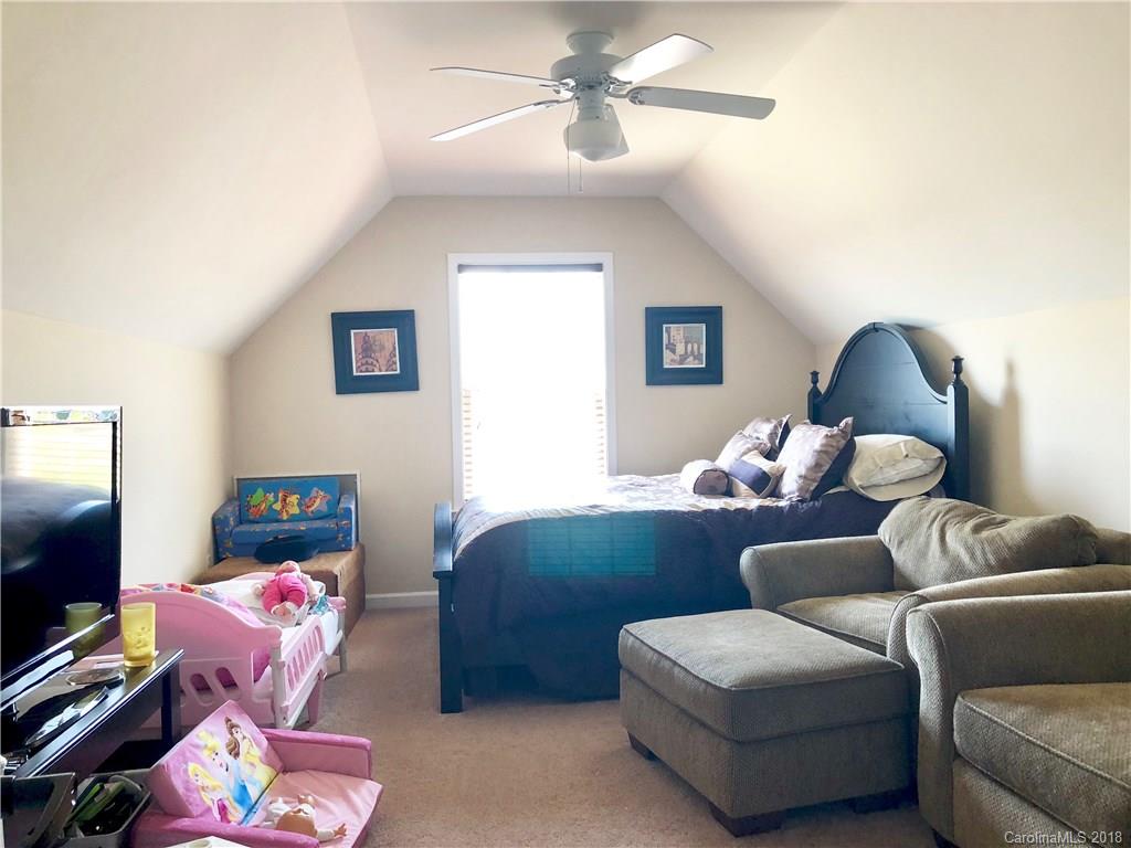 277 Yadkin Road Fletcher, NC 28732 - Photo 10 of 15 a living room with furniture a flat screen tv and a window