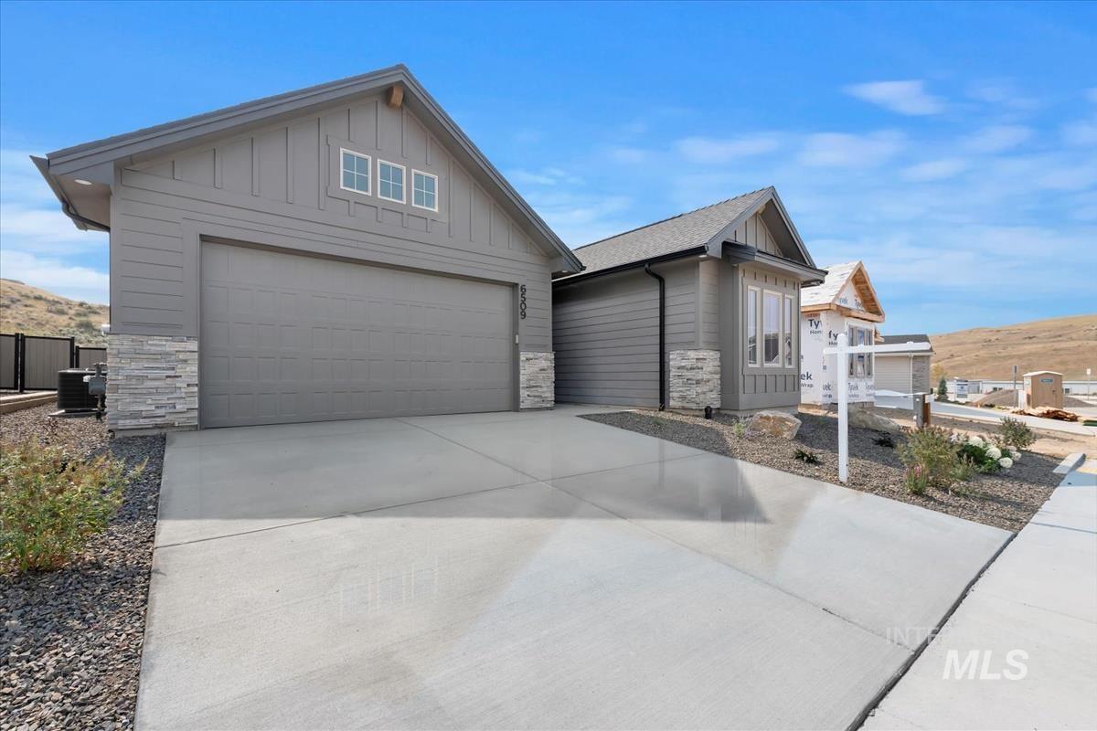 2166 East Rodeo Street Kuna, ID 83634 - Photo 41 of 43 Contemporary single-story residence featuring grey siding and a stacked stone facade