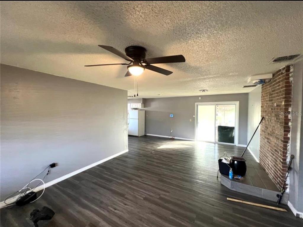 7004 Clarcona Ocoee Road Orlando, FL 32818 - Photo 2 of 10 wooden floor in an empty room with a window