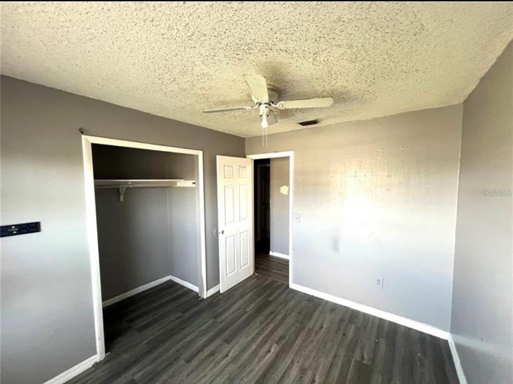 7004 Clarcona Ocoee Road Orlando, FL 32818 - Photo 6 of 10 a view of an empty room with wooden floor