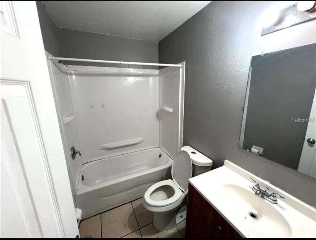 7004 Clarcona Ocoee Road Orlando, FL 32818 - Photo 8 of 10 a bathroom with a sink toilet and shower