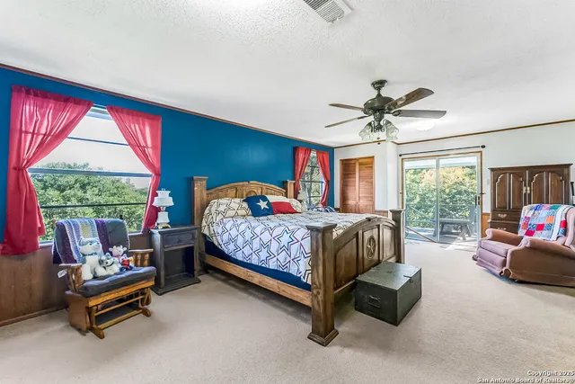 a bedroom with a bed and a large window