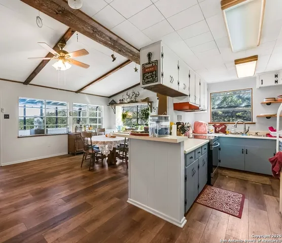 a kitchen with lots of counter top space and dining table