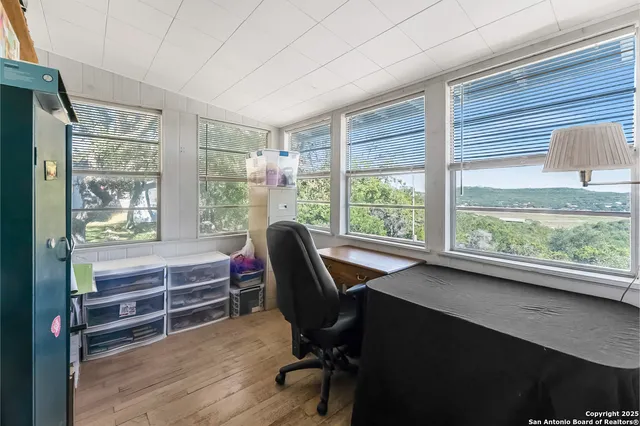 a view of a workspace with furniture and a window
