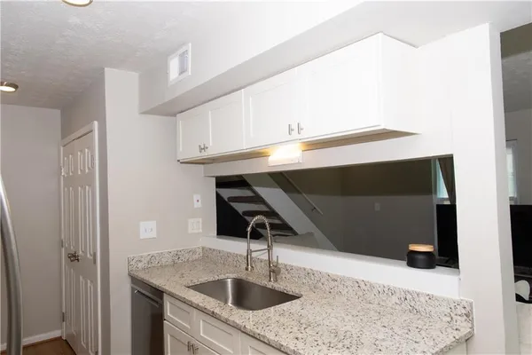 a kitchen with a sink and a mirror
