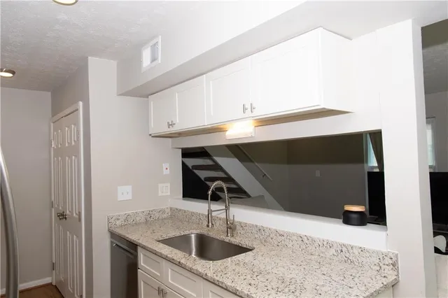 a kitchen with a sink and a mirror