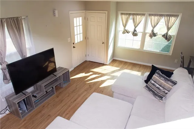 a bedroom with a bed tv and a window