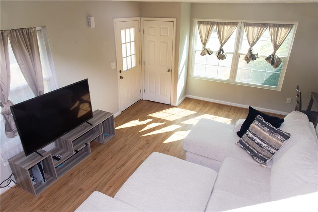 1311 Old Coach Road Southwest Marietta, GA 30008 - Photo 4 of 8 a bedroom with a bed tv and a window