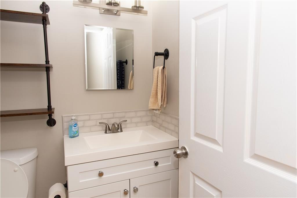 1311 Old Coach Road Southwest Marietta, GA 30008 - Photo 5 of 8 a bathroom with a sink and a mirror