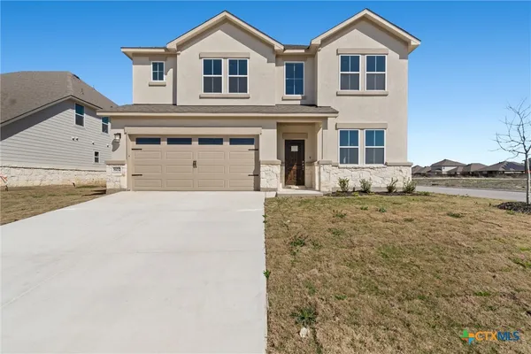 a front view of a house with a yard