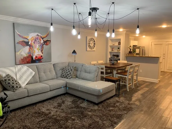 a living room with furniture and a chandelier