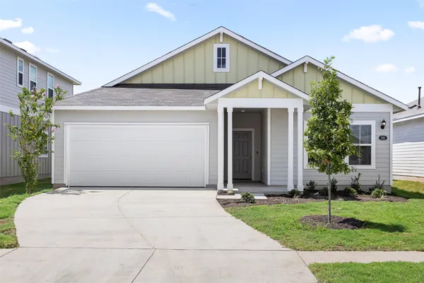 a front view of house with garage and yard