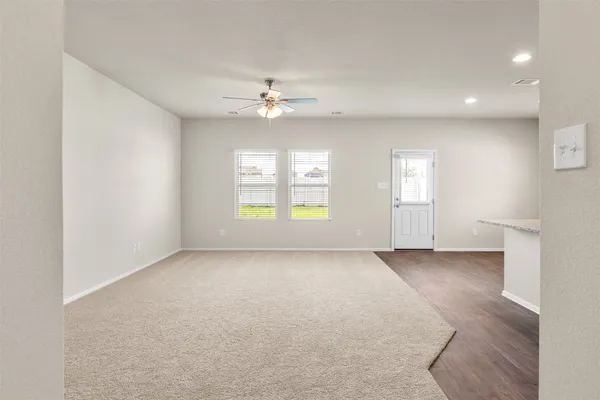 a view of kitchen with sink and refrigerator