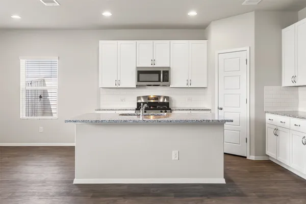 a large kitchen with cabinets and stainless steel appliances