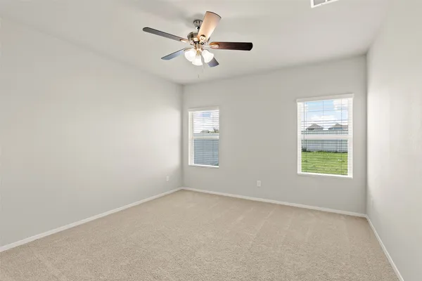 a view of an empty room with a ceiling fan